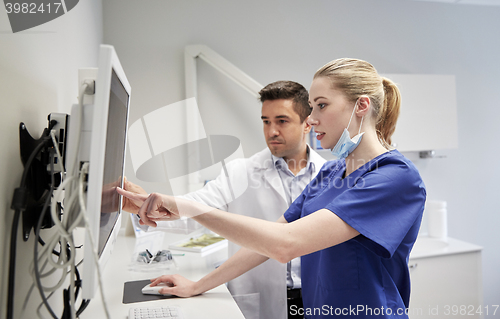 Image of dentists with x-ray on monitor at dental clinic