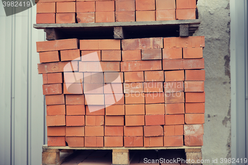 Image of brown bricks batch on wooden storage tray