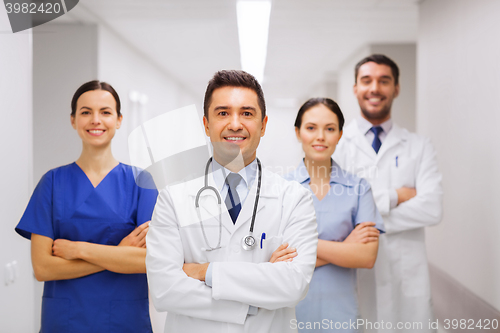 Image of happy group of medics or doctors at hospital