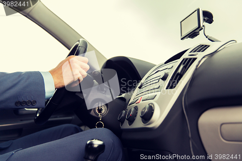 Image of close up of man with gps navigator driving car