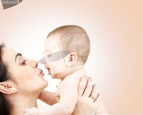 Image of happy mother kissing adorable baby