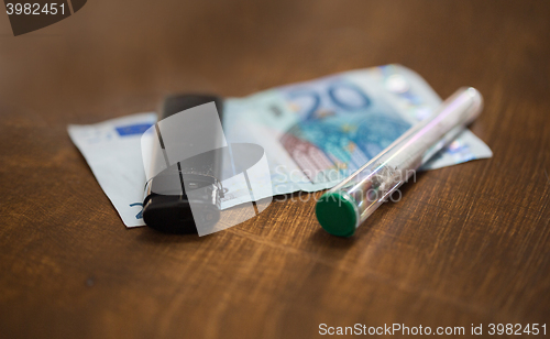 Image of close up of marijuana joint and money