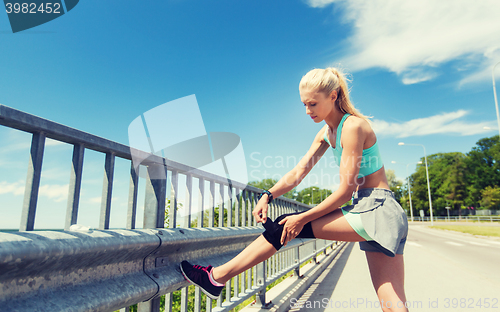 Image of young woman with injured knee or leg outdoors