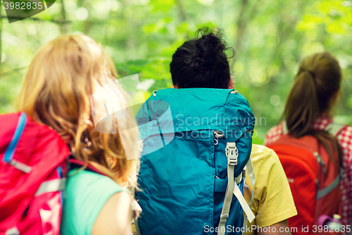 Image of close up of friends with backpacks hiking