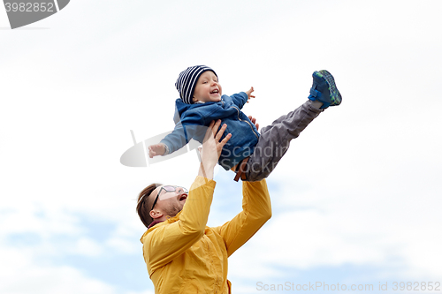 Image of father with son playing and having fun outdoors