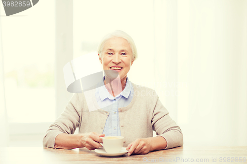 Image of happy senior woman with cup of coffee