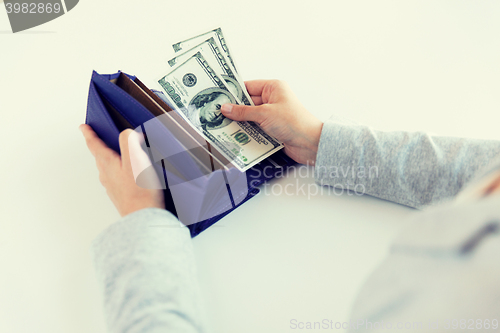 Image of close up of woman hands with wallet and money