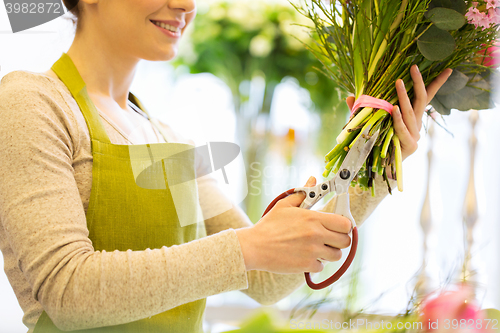 Image of close up of woman with flowers and scissors