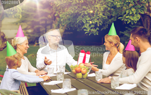 Image of happy family having holiday dinner outdoors