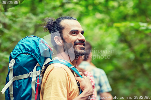 Image of group of smiling friends with backpacks hiking