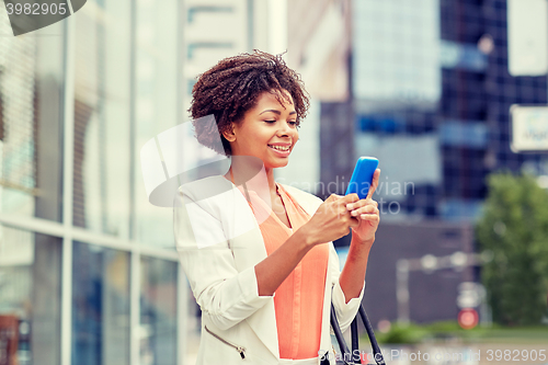 Image of happy african businesswoman with smartphone