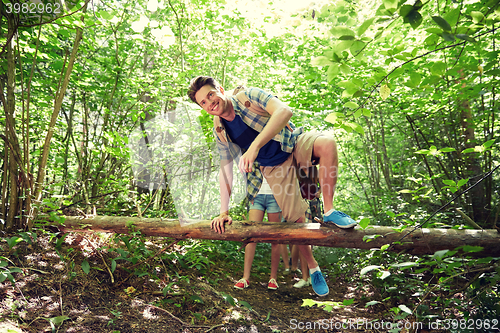 Image of group of smiling friends with backpacks hiking