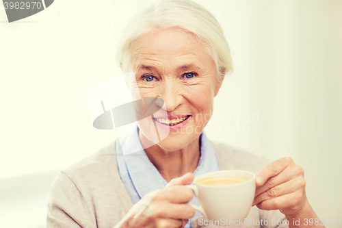 Image of happy senior woman with cup of coffee