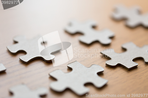 Image of close up of puzzle pieces on wooden surface