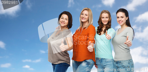 Image of group of happy different women showing thumbs up