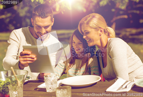 Image of happy family with tablet pc outdoors