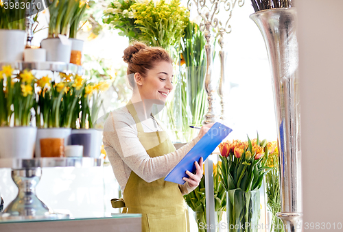 Image of florist woman with clipboard at flower shop