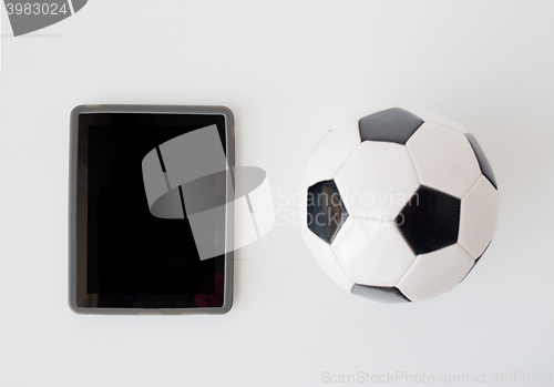 Image of close up of football or soccer ball and tablet pc