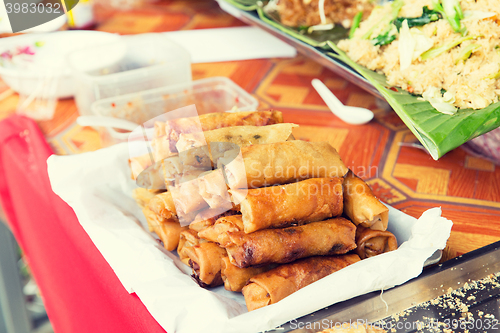 Image of spring rolls and snacks at street market