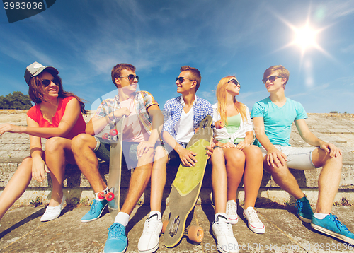 Image of group of smiling friends sitting on city street