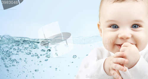 Image of happy baby over blue background with water splash