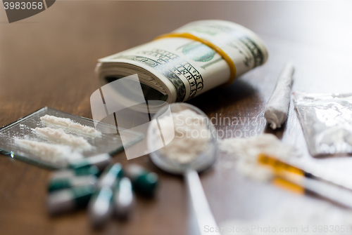 Image of close up of drugs, money, spoon and syringe