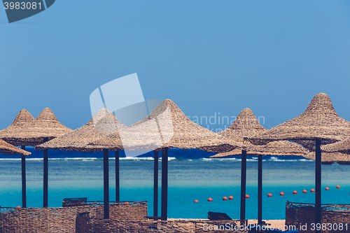 Image of Beach umbrellas and blue sky background