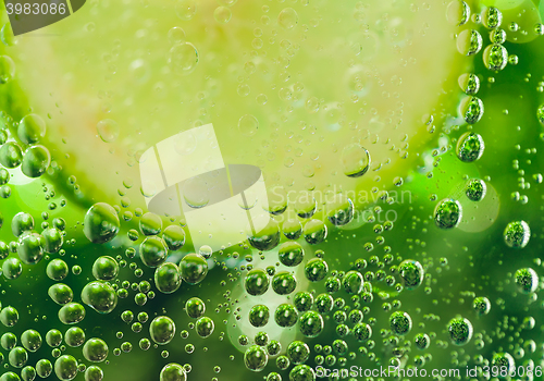 Image of lemon in sparcle water drops