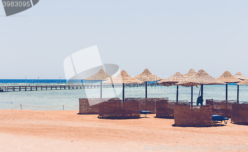 Image of Beach umbrellas and blue sky background