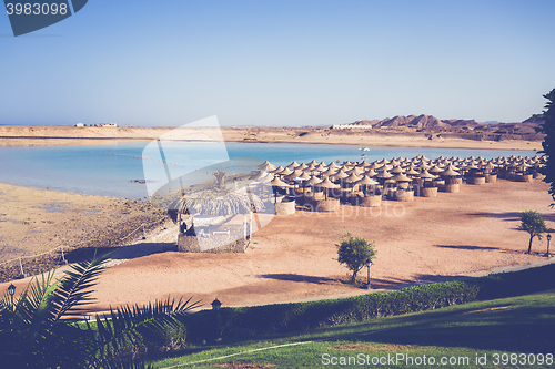 Image of Beach umbrellas and blue sky background