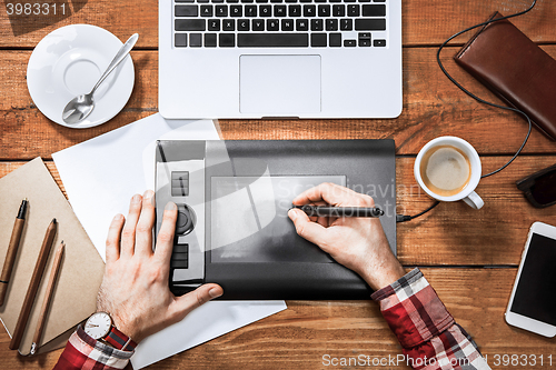 Image of Graphic Designer working with interactive pen display, digital Drawing tablet and Pen on a computer