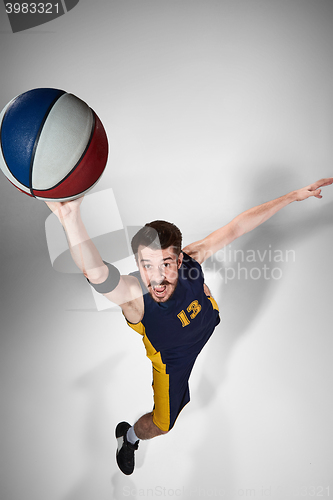 Image of Full length portrait of a basketball player with ball