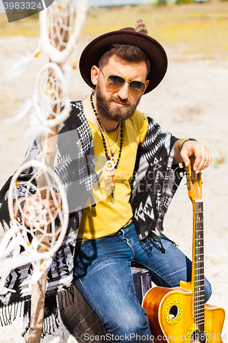 Image of Man as boho hipster against blue sky