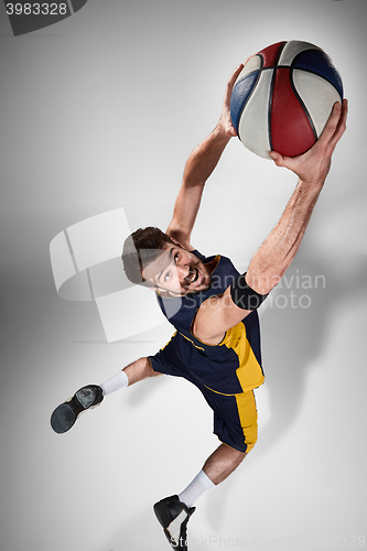 Image of Full length portrait of a basketball player with ball