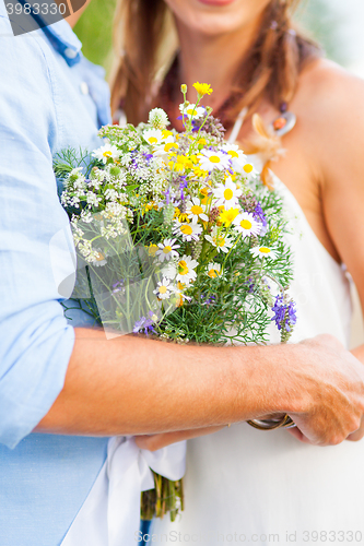 Image of The crop image of romantic couple with flowers