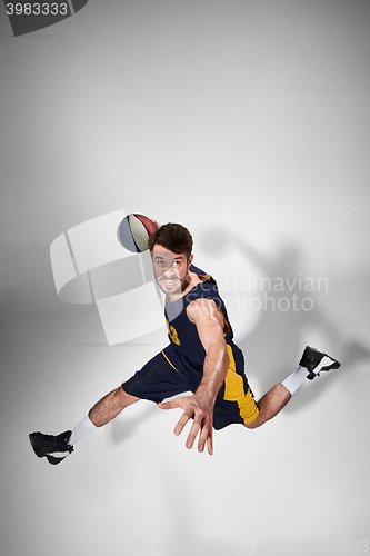 Image of Full length portrait of a basketball player with ball