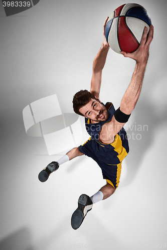 Image of Full length portrait of a basketball player with ball