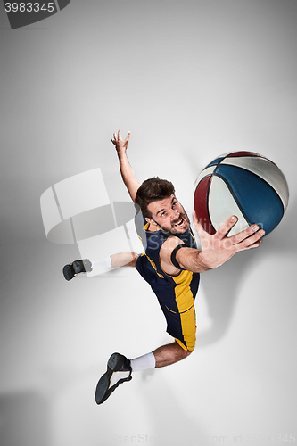 Image of Full length portrait of a basketball player with ball