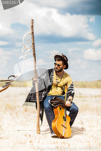 Image of Man as boho hipster against blue sky