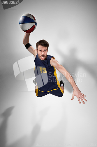 Image of Full length portrait of a basketball player with ball