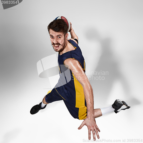 Image of Full length portrait of a basketball player with ball