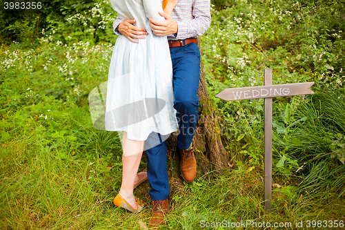 Image of The crop image of romantic couple with green grass
