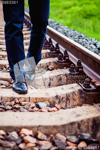 Image of The man walking on the railway sleepers