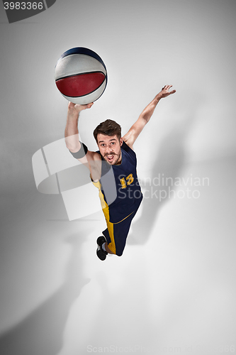 Image of Full length portrait of a basketball player with ball