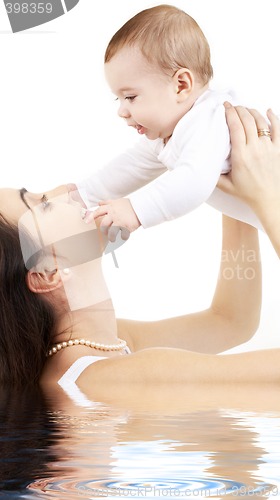 Image of happy mother with baby boy in water #2