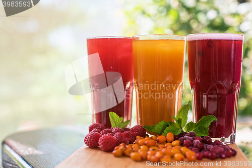 Image of fruit drink with cranberries raspberries and sea buckthorn