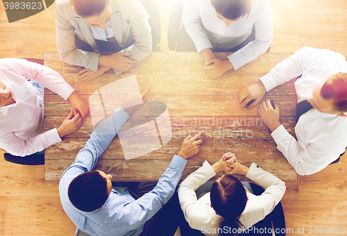 Image of close up of business team sitting at table