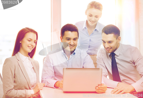 Image of business team working with laptop in office