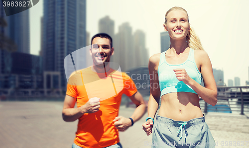 Image of couple running over dubai city street background