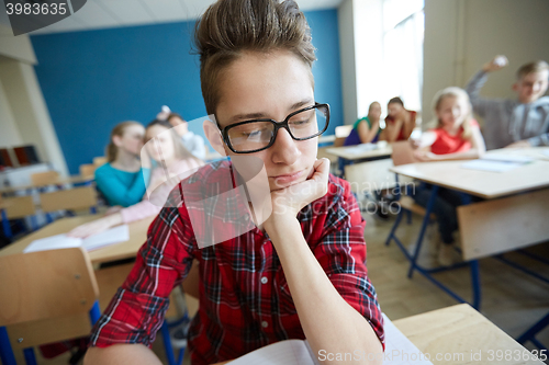 Image of students gossiping behind classmate back at school